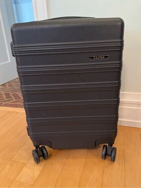 Calpak carry on size expandable hardshell suitcase luggage in black